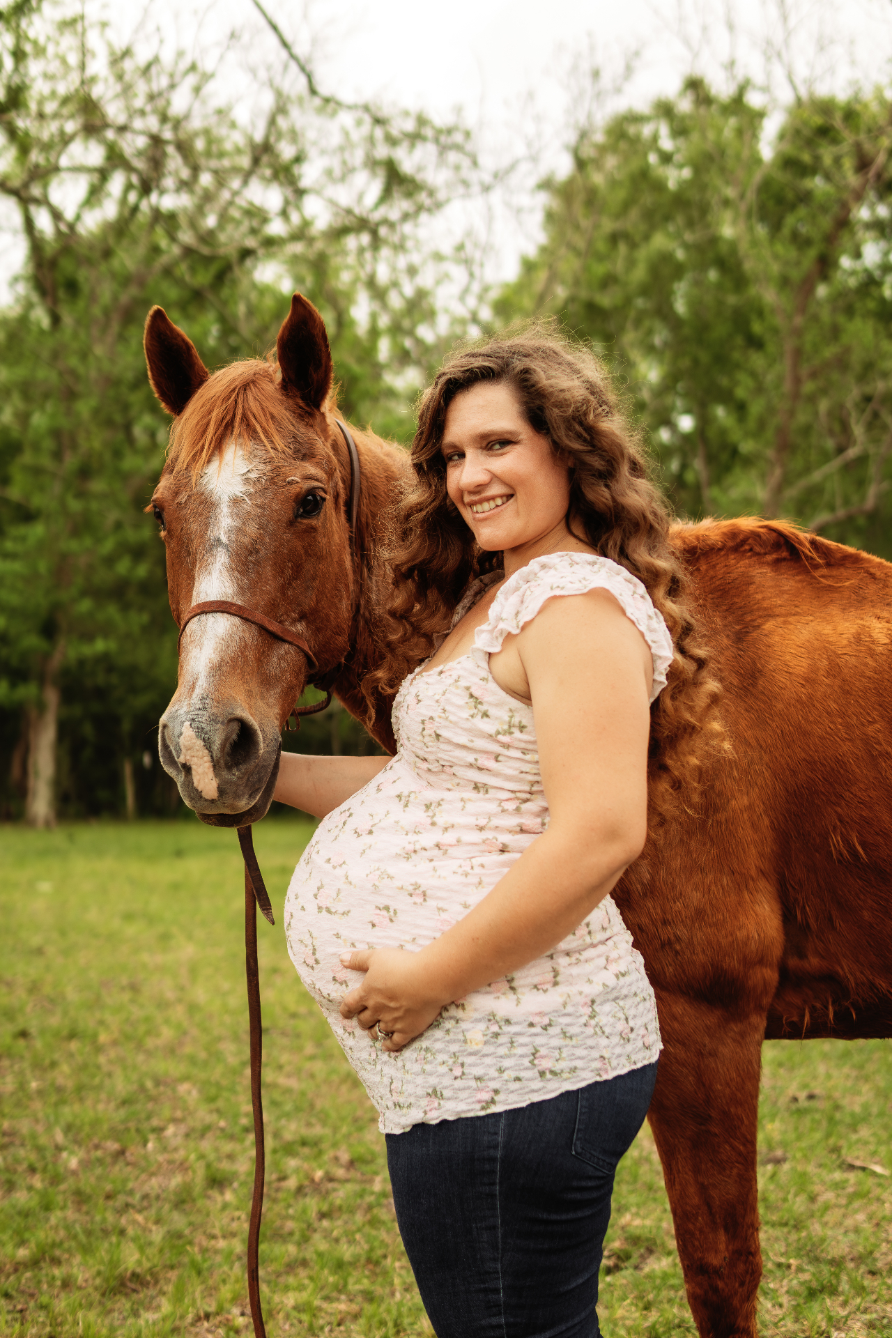 Madisson, founder of Love Posted, standing with her horse